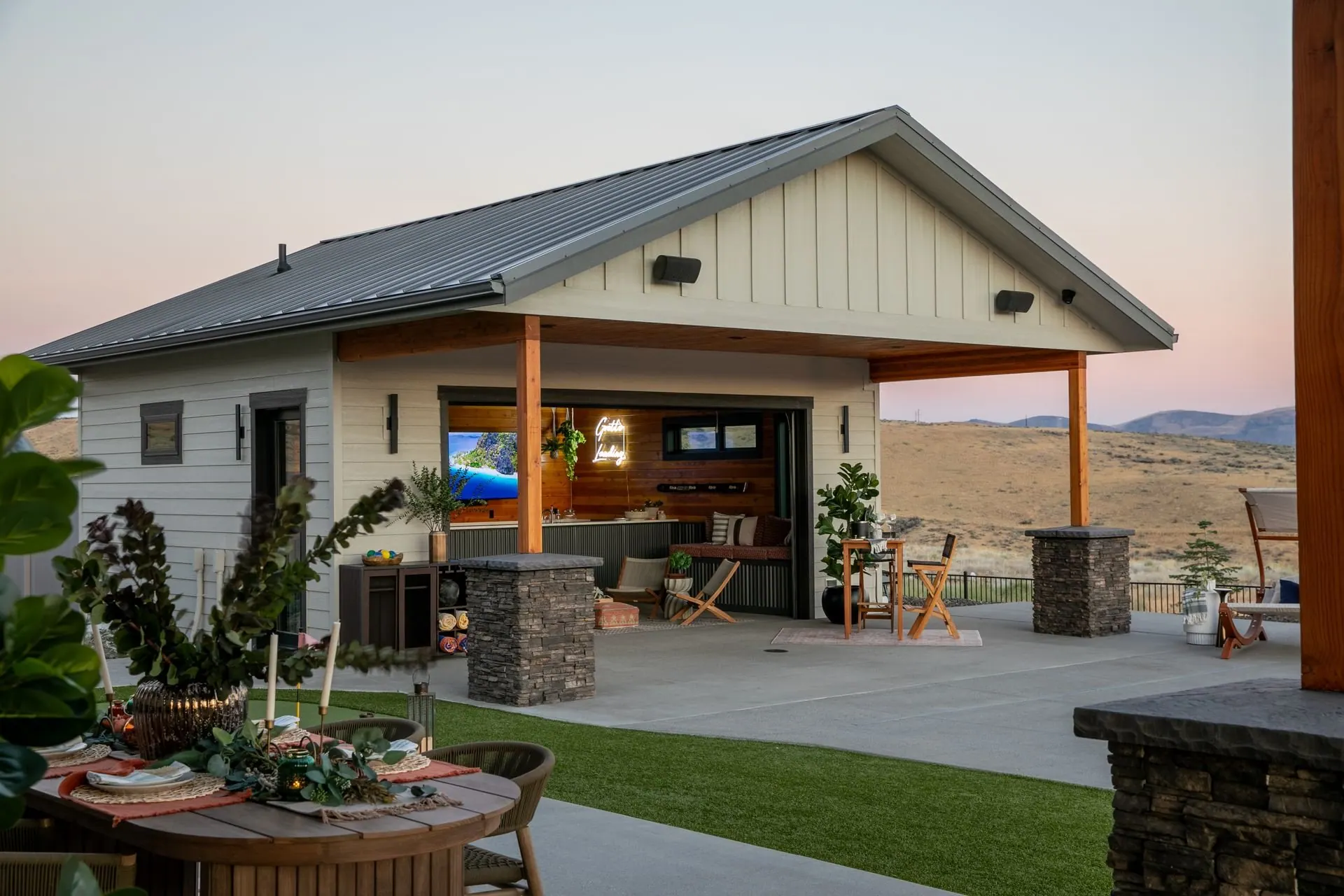 Newly constructed Pacific Northwest home with covered outdoor living space and sweeping valley views