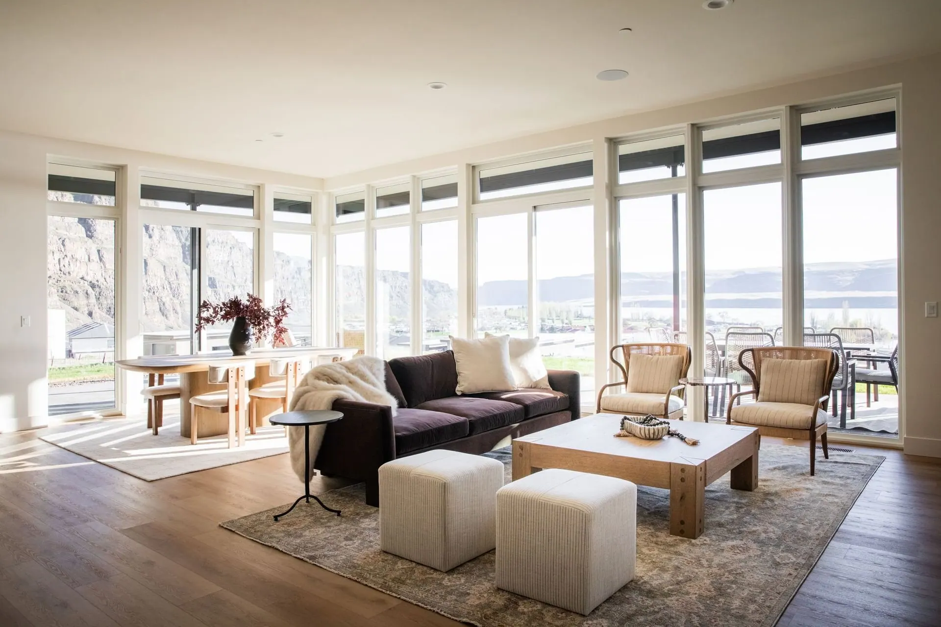 Bright living room designed by Dwelling Design with large windows and mountain views